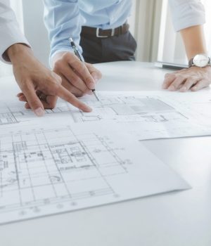 Image of engineer meeting for architectural project. working with partner and engineering tools on workplace vintage tone.