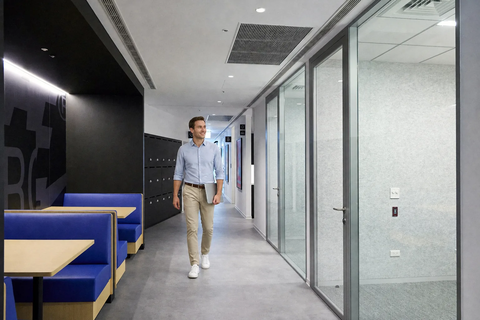 Office corridor with Optima acoustic glass partitions and booth seating
