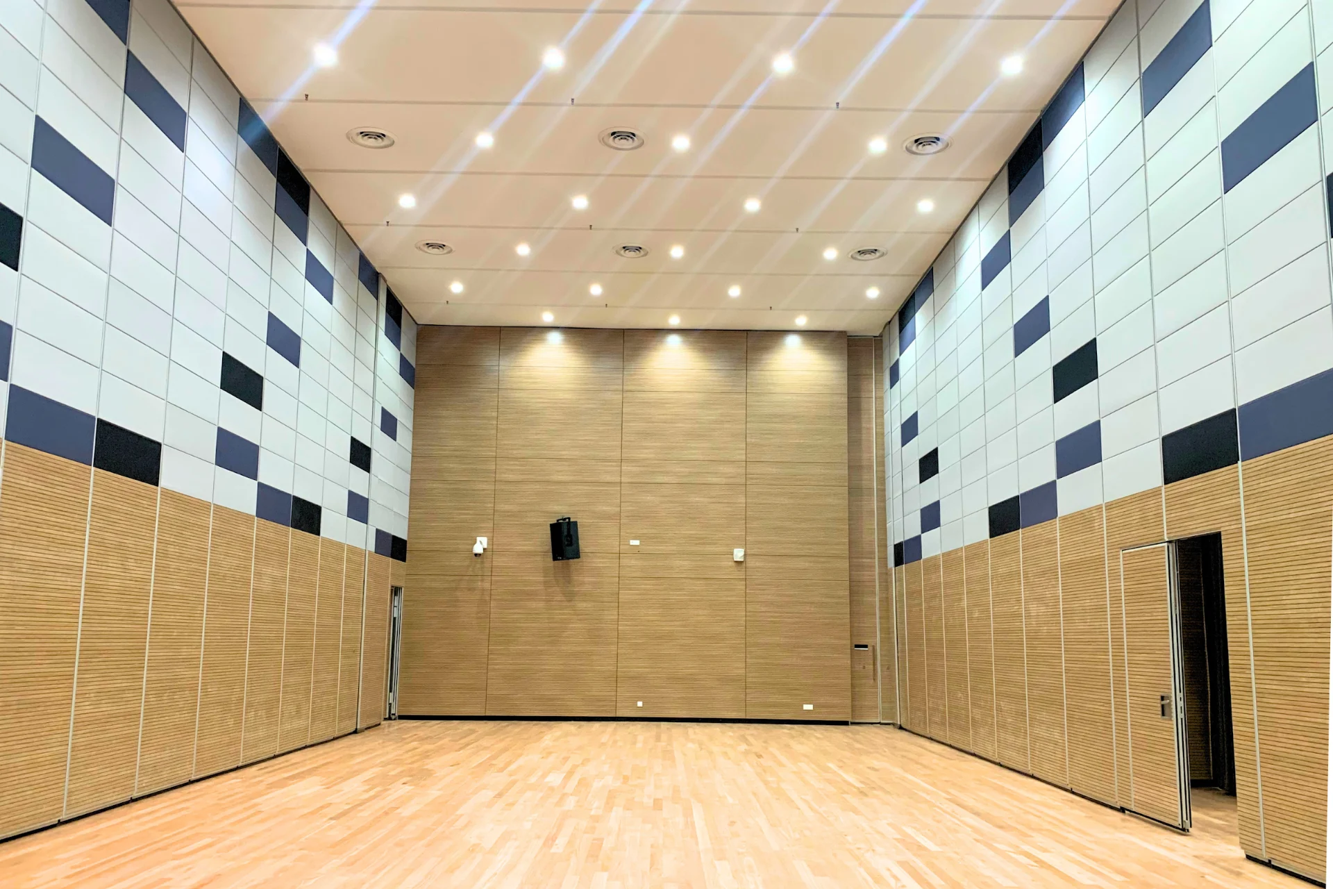 IWC BOZ solid operable wall in a high-ceiling multipurpose hall